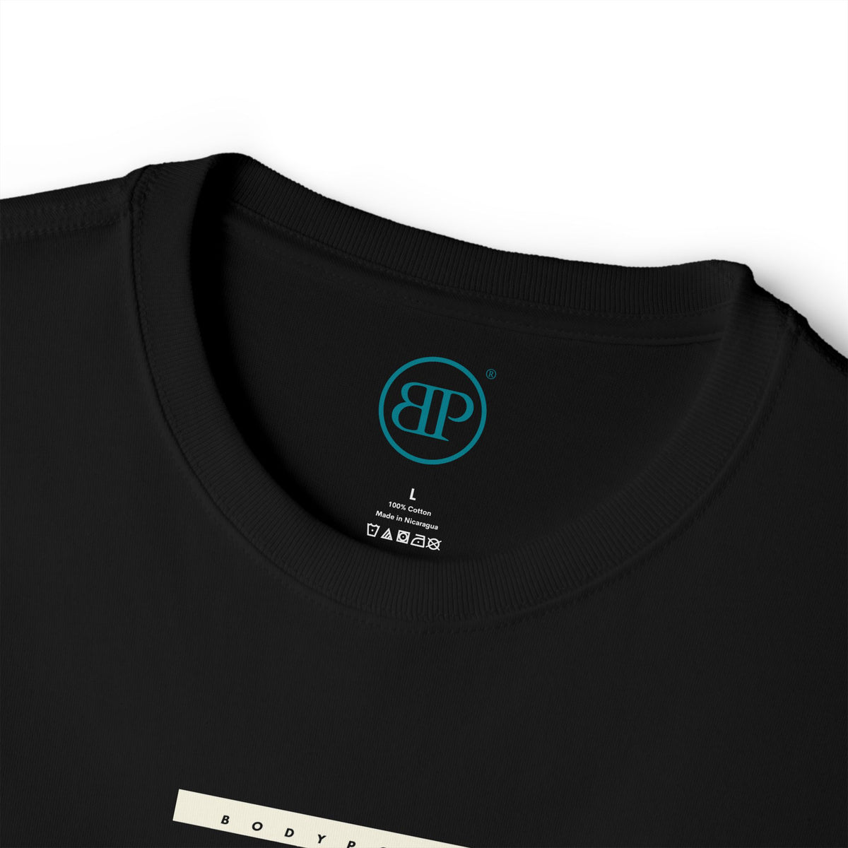 Inside collar of the black Unisex Boxy tee with printed Bodypoint BP neck label